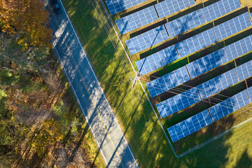 Aerial view of large sustainable electrical power plant with rows of solar photovoltaic panels for producing clean electric energy. Concept of renewable electricity with zero emission