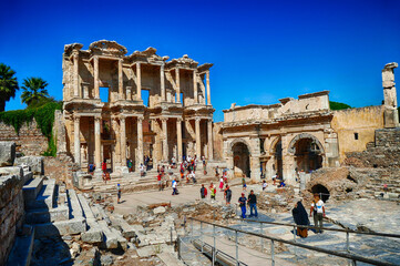 Tourists explore the Library of Celsus