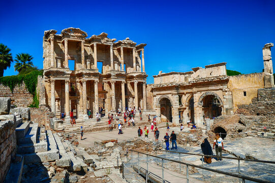 Fototapeta Tourists explore the Library of Celsus