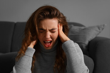 Young woman having panic attack at home