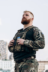 Portrait of Ukrainian soldier in uniform on the street