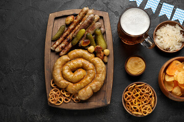 Mug of cold beer and different snacks on black background. Oktoberfest celebration