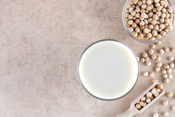 Chickpea milk with chickpeas on a beige background. Top view. Copy Space.