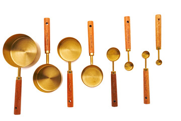 Copper Measuring spoon set with Wooden Handles on white background.