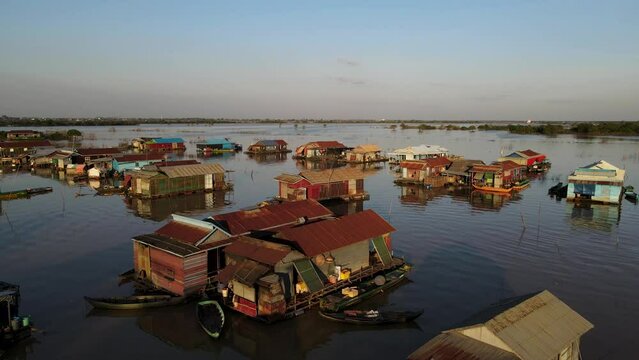 Houses on water, 4k Drone footage of a floating village during sunset, Kampong Phluk, Cambodia, Boats, fisherman