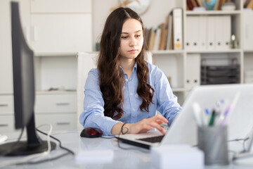 Portrait of young business woman in modern office