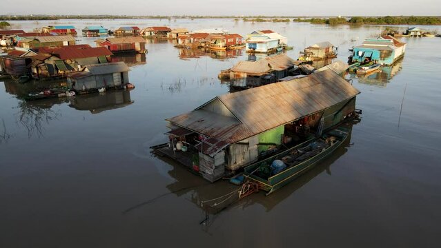 House on river with a dog, 4k Drone footage of a floating village during sunset, Kampong Phluk, Cambodia, Boats, fisherman