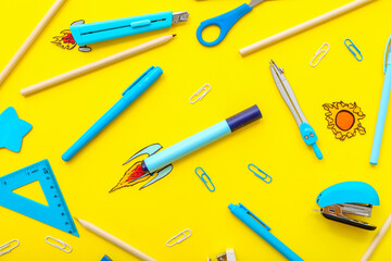 Creative composition with paper rockets and different stationery on yellow background