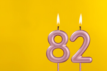 Birthday candle number 82 - Birthday celebration on yellow background