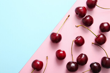 Many sweet cherries on colorful background