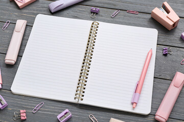 Blank notebook with different stationery on grey wooden background