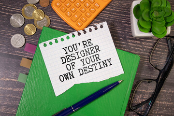 Arrow on asphalt road written word you're designer of your own destiny