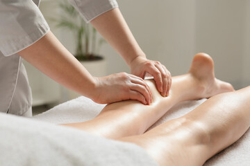 Woman receiving leg massage in spa salon, closeup - obrazy, fototapety, plakaty