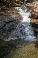 Waterfall in the mountain falls into the well of crystal clear water, Sodrelandia waterfall