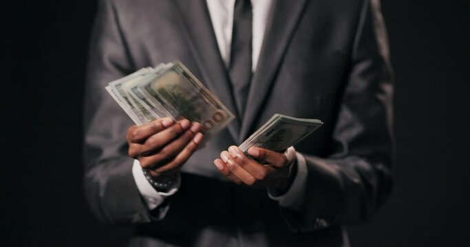 African American man lottery winner, marveling at the unexpected windfall in his hands close up shot selective focus.