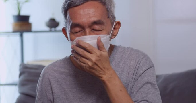 An Elderly Asian Man Wearing A Mask While Having A Respiratory Illness.