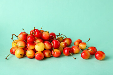 Heap of sweet yellow cherries on blue background