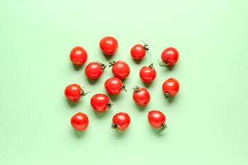 Naklejka na ściany i meble Many fresh cherry tomatoes on green background