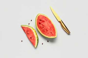 Pieces of fresh watermelon and seeds on grey background