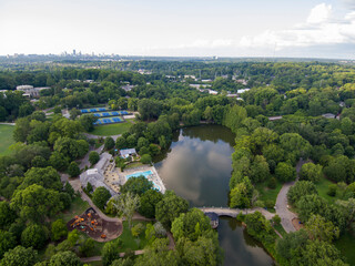 aerial shot of the green waters of Lake Clara Meer with lush green trees, grass and plants, tennis...