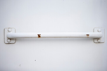 Old white door handle on a white background. Close-up.