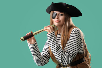 Beautiful female pirate with spyglass on green background