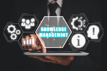 knowledge management concept, Businessman using digital tablet with knowledge management icon on...