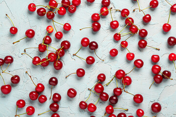Many red sweet cherries on blue background