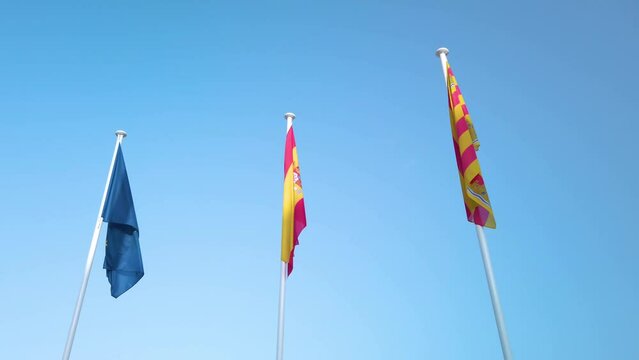 EU flag Spanish flag local Ibiza flag wave in wind