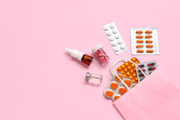 Shopping bag with different pills on pink background
