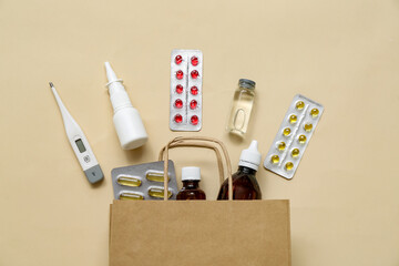 Shopping bag with different medicines on brown background