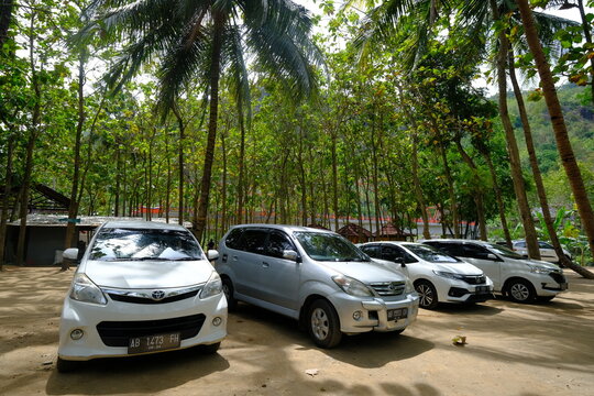 Toyota Avanza car in tropical parking lot