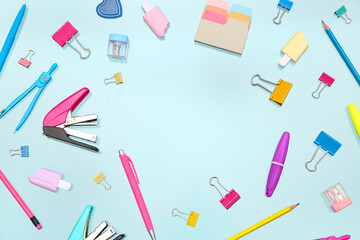 Frame made of stationery on blue background