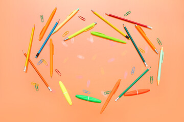 Frame made of stationery on orange background