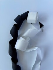 white and black ribbons on white background 