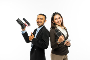 a male journalist standing with thumb up and bring the camera at his right hand with a beautiful...
