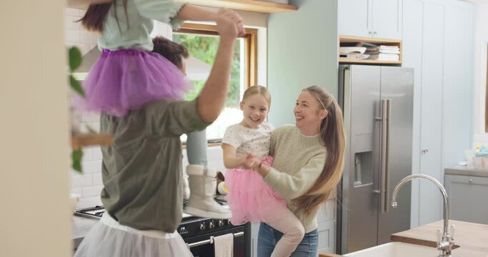 Home, dance and family with love, energy and wellness with freedom, kitchen and playful together. Parents, happy mother and father with children, kids and bonding with joy, apartment and performance