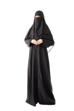 muslim woman wearing a black hijab or niqab and long dress standing in white background holding hands