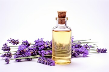 Lavender essential oil bottle with a sprig of lavender on white background for use in the spa with massage, aromatherapy.