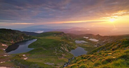 Sunrise above bulgarian mountain peaks, hills, Seven Rila Lakes and clouds, 4K video nature of Bulgaria