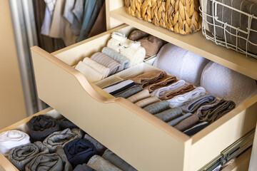 Drawer in the wardrobe with women's underwear, bras, briefs, socks and t-shirts. The concept of...