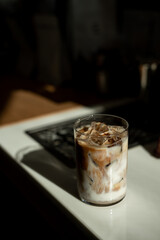 Iced coffee in plastic cup on table in coffee shop