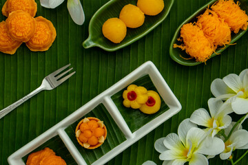 Thai traditional dessert concept, Assorted Thai dessert served in a plate on banana leaf background