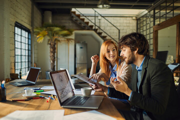 Young man and woman working on a project