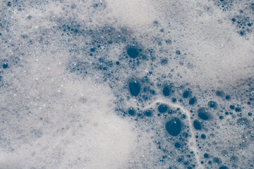 Detergent foam bubble on water. Blue background, Soap sud
