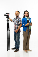 a beautiful reporter in blue cardigan and a cameraman with one set of camera standing back to back