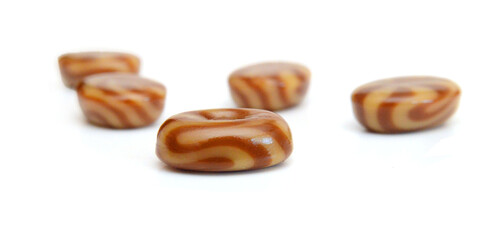 Caramel candies isolated on white background