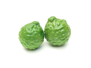 Fototapeta premium Fresh organic kaffir lime green The cut into pieces, rough skin, bergamot has many uses commonly used as a shampoo Or kaffir lime skin can be used as an ingredient in food put on a white background. 