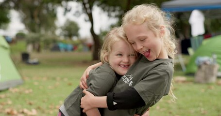 Family, camp and face of girl children hug a forest, fun and bonding on vacation outdoors. Camping, kids and portrait of sisters hug, smile and happy in nature, playful and enjoy holiday in woods
