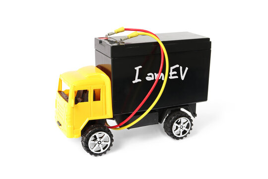 Electric Vehicle EV illustrated by Toy Truck carrying a Big Battery Reflecting the Battery Weight Problem Concept Abstract on white background with clipping paths of the Objects